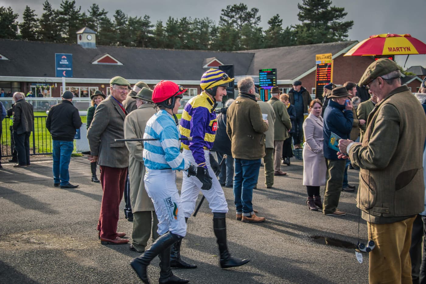 Jockeys and racegoers in the parade ring at Ludlow