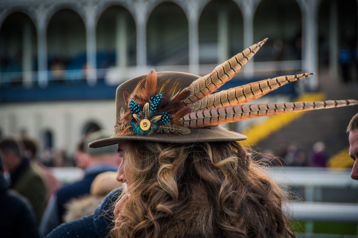 Racegoer in a feathered hat at Ludlow